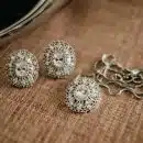 three pieces of jewelry sitting on top of a table