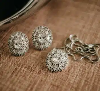 three pieces of jewelry sitting on top of a table