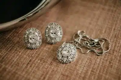 three pieces of jewelry sitting on top of a table