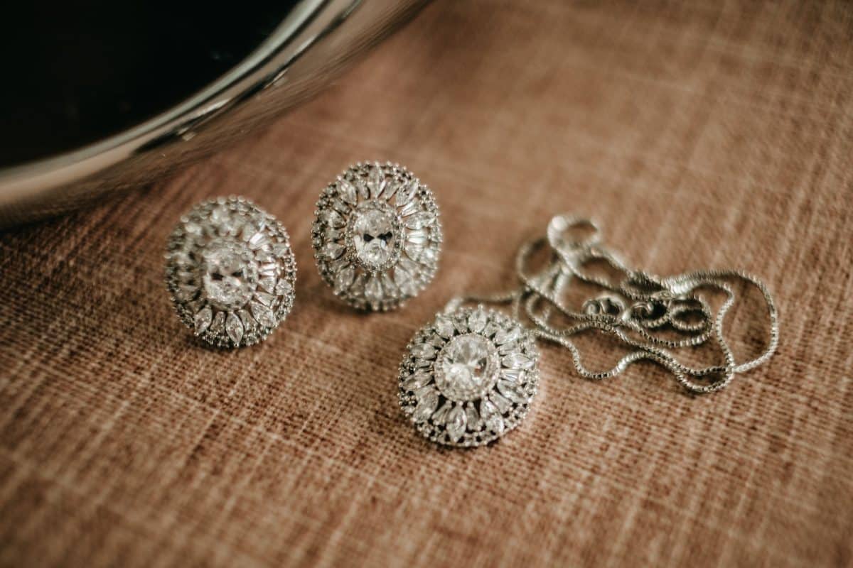 three pieces of jewelry sitting on top of a table